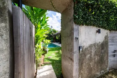 an entrance to a backyard with a wooden fence at Anggana Villa 2 in Canggu