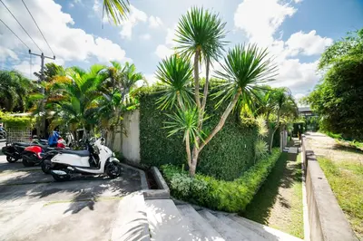 a scooter parked on a street with palm trees at Anggana Villa 2 in Canggu