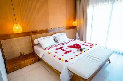 a bed with a cake on it in a room at Pradha Kuta, 3 BDR, 3 minutes from seminyak beach in Seminyak