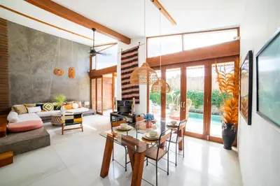 a living room with a table and a couch at Anggana Villa 3 in Canggu