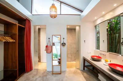 a bathroom with a red sink and a large mirror at Anggana Villa 3 in Canggu
