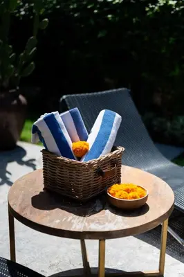 a basket of towels and a bowl of food on a table at Anggana Villa 3 in Canggu