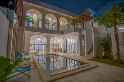 a house with a swimming pool and a balcony at Stunning tropical 3bed Villa in Canggu