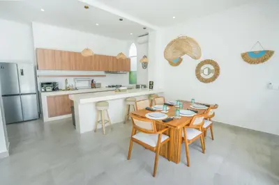 a kitchen and dining room with a table and chairs at Stunning tropical 3bed Villa in Canggu