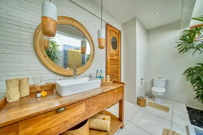 a bathroom with a sink and a mirror at Chic Tranquility Modern yet Timeless 3BD Villa in Canggu