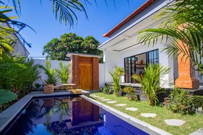 a house with a swimming pool in front of a house at Viewbali 1 - Villa with Jungle Garden Big Pool and Kitchen in Kerobokan