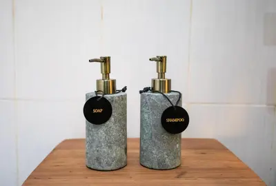 two bottles sitting on top of a wooden table at Villa Shiro in Seminyak