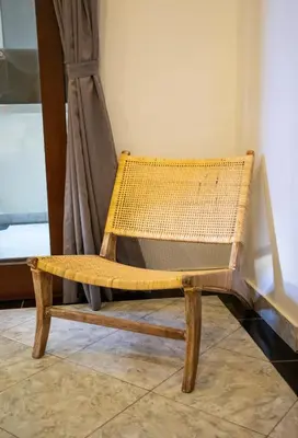 a wooden bench sitting in front of a window at Villa Shiro in Seminyak