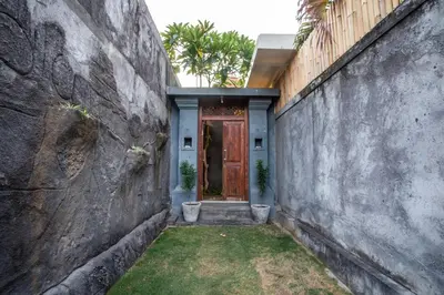 a entrance to a house with a wooden door at Villa Shiro in Seminyak