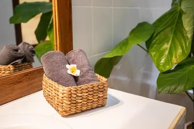 a basket sitting on a table in front of a mirror at Villa Shiro in Seminyak