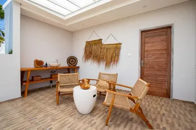 a living room with two chairs and a table at Sunterra Villa with Ricefield View in Canggu in Kerobokan