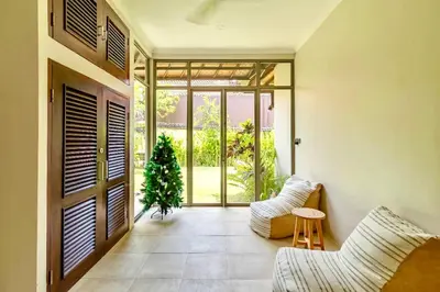 a living room with a christmas tree in front of a door at Mantra Dom Villa 3 Bedrooms in Canggu
