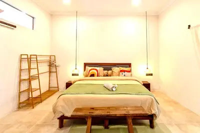 a bedroom with a bed and a ladder at Mantra Dom Villa 3 Bedrooms in Canggu