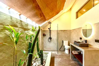 a bathroom with a shower and a toilet and a sink at Mantra Dom Villa 3 Bedrooms in Canggu