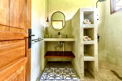 a bathroom with a sink and a mirror at Mantra Dom Villa 3 Bedrooms in Canggu