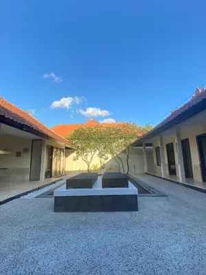 a bench in the middle of a courtyard at Sorry we close in Seminyak