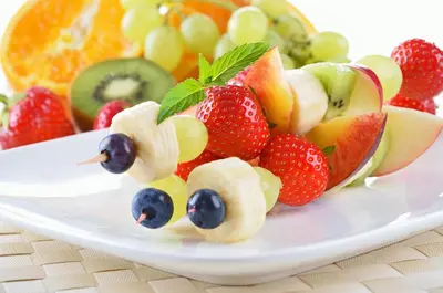 a plate of fruit with a face made out of fruit at Seminyak Villa in Seminyak