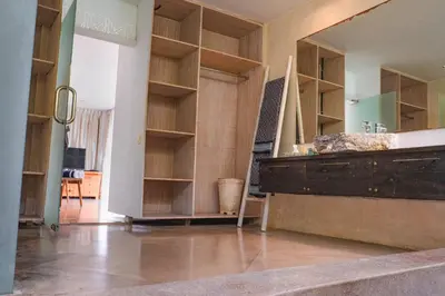 a room with wooden shelves and a large mirror at Villa Marie Clare in Seminyak
