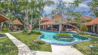 a swimming pool in the yard of a house at Des Indes Villas in Seminyak