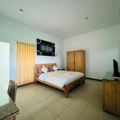 a bedroom with a bed in a room at Adijaya Rooms in Seminyak