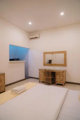 a room with a mirror and a sink and a table at Adijaya Rooms in Seminyak