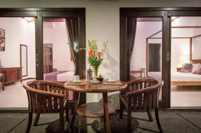 a room with a table and two chairs and a bedroom at 2 Bedroom Private Pool walking distance to the Seminyak beach in Seminyak