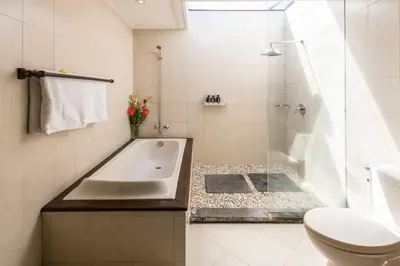 a bathroom with a tub and a toilet and a sink at 2 Bedroom Private Pool walking distance to the Seminyak beach in Seminyak