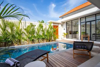 a villa with a swimming pool and a house at Kubung 1 - Villa with HUGE Pool and PS5 in Kerobokan