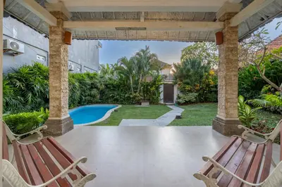 a patio with two chairs and a swimming pool at Villa Selamat, Seminyak, Batu Belig, 10 min from beach in Seminyak