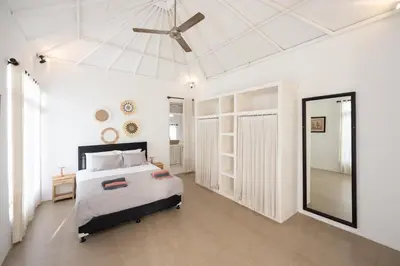 a bedroom with a bed and a ceiling fan at Villa Selamat, Seminyak, Batu Belig, 10 min from beach in Seminyak