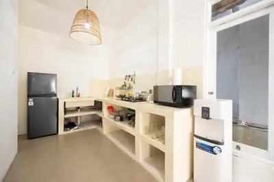 a kitchen with a refrigerator and a microwave at Villa Selamat, Seminyak, Batu Belig, 10 min from beach in Seminyak