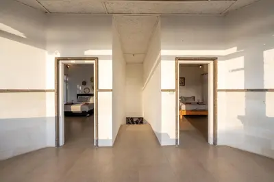 a hallway with two doors and a room with a bed at Villa Selamat, Seminyak, Batu Belig, 10 min from beach in Seminyak