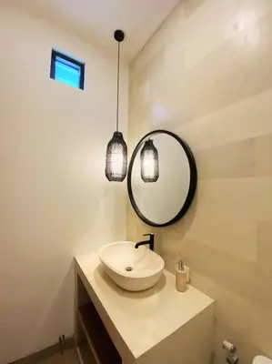 a bathroom with a sink and a mirror at Cosy 2bed/2bath villa 5 min to beach in Dalung