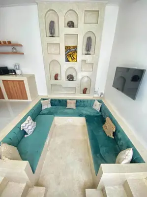 a living room with a blue couch and a tv at Cosy 2bed/2bath villa 5 min to beach in Dalung