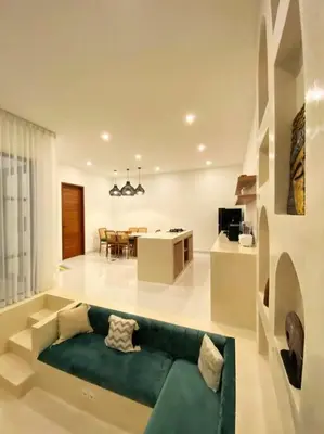 a living room with a green couch and a dining room at Cosy 2bed/2bath villa 5 min to beach in Dalung