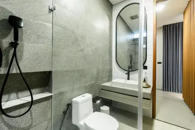 a bathroom with a toilet and a sink and a mirror at Villa Elena by Maheswara in Seminyak