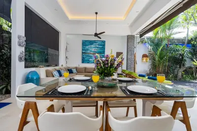 a dining room with a glass table and chairs at Villa Céline 1 Bdr pool Seminyak in Seminyak