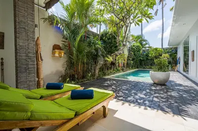 a patio with a couch and a swimming pool at Villa Céline 1 Bdr pool Seminyak in Seminyak