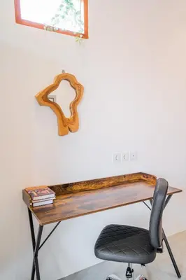 a desk with a chair in front of a wall at NEW! Villa Sony 2 - 3BR villa next to Legian Beach in Seminyak
