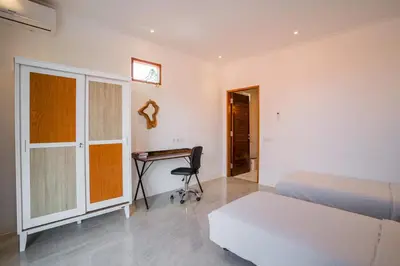 a bedroom with a bed and a desk in it at NEW! Villa Sony 2 - 3BR villa next to Legian Beach in Seminyak