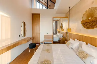 a bedroom with a large bed in a room at Vin Villa Seminyak 2BR with Private Pool in Seminyak