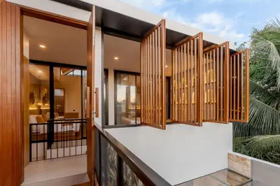 a balcony of a house with wooden windows at Vin Villa Seminyak 2BR with Private Pool in Seminyak