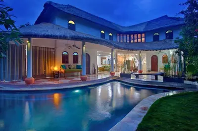 a villa with a swimming pool at night at Rose 2BR Private Pool Villa in Kerobokan