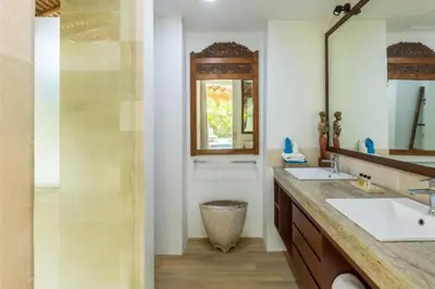 a bathroom with two sinks and a mirror at Hazel Azalea 4 BR Private Pool Villa in Seminyak