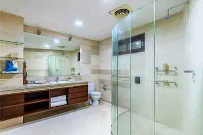 a bathroom with a glass shower and a toilet at House Lizard 3 BR Private Pool Villa in Kerobokan