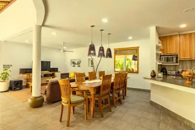 a kitchen and dining room with a table and chairs at House Lizard 3 BR Private Pool Villa in Kerobokan