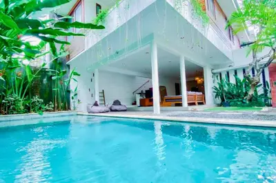 a swimming pool in front of a house at Luxury 2 BR Private Pool Villa ZN101 in Seminyak