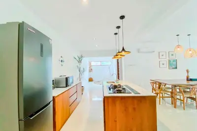 a kitchen with a stainless steel refrigerator and a table at Luxury 2 BR Private Pool Villa ZN101 in Seminyak