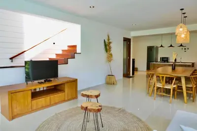 a living room with a television and a dining room at Luxury 2 BR Private Pool Villa ZN101 in Seminyak
