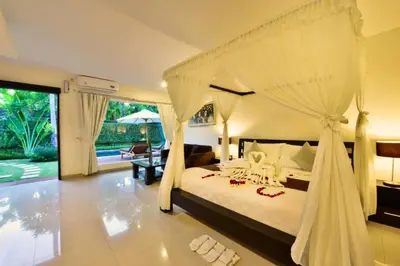 a bedroom with a large bed with a canopy at Lavender 1 BR Private Pool Villa in Seminyak